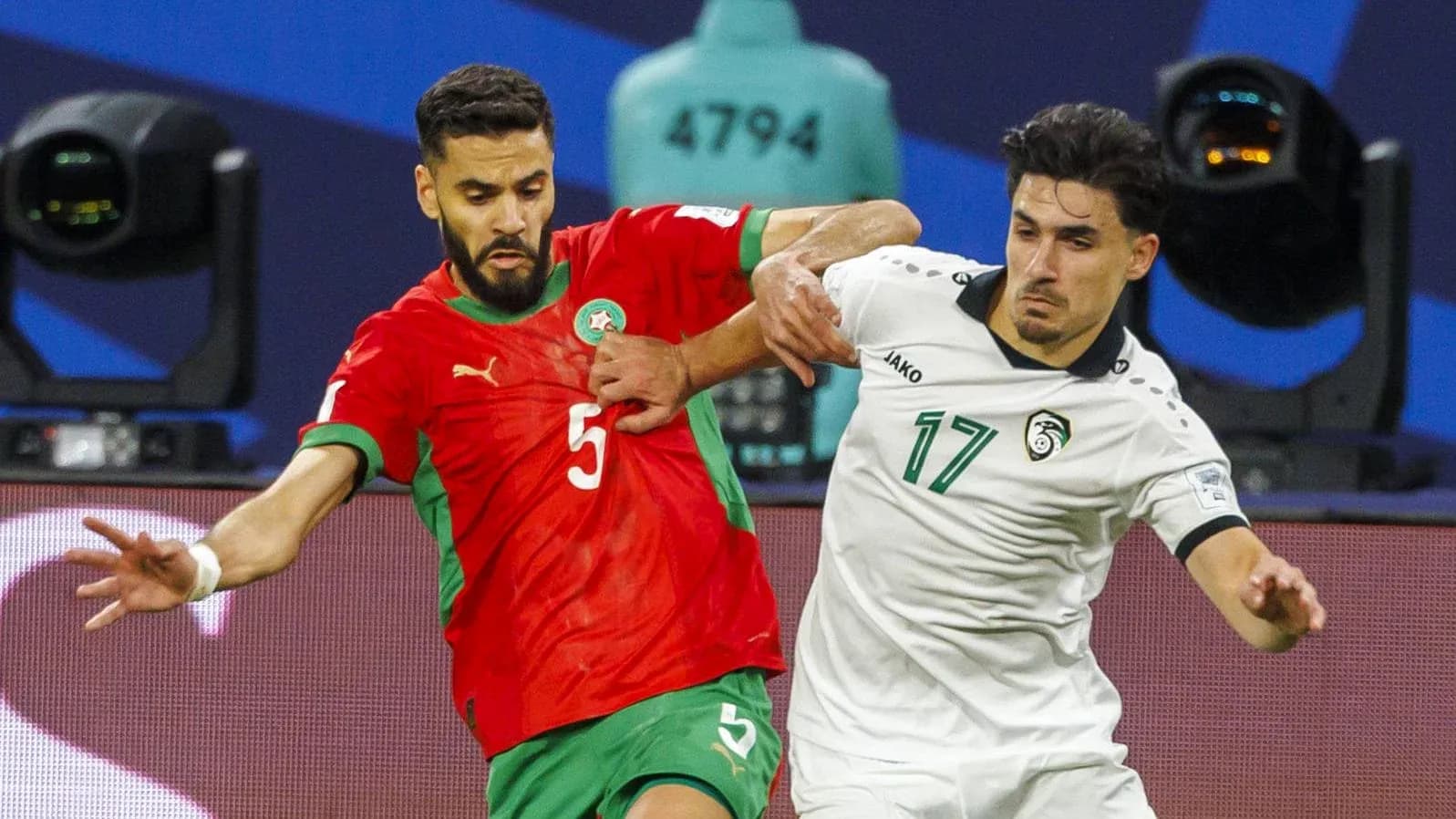 Two players competing for the ball during a match Two players competing for the ball during a match