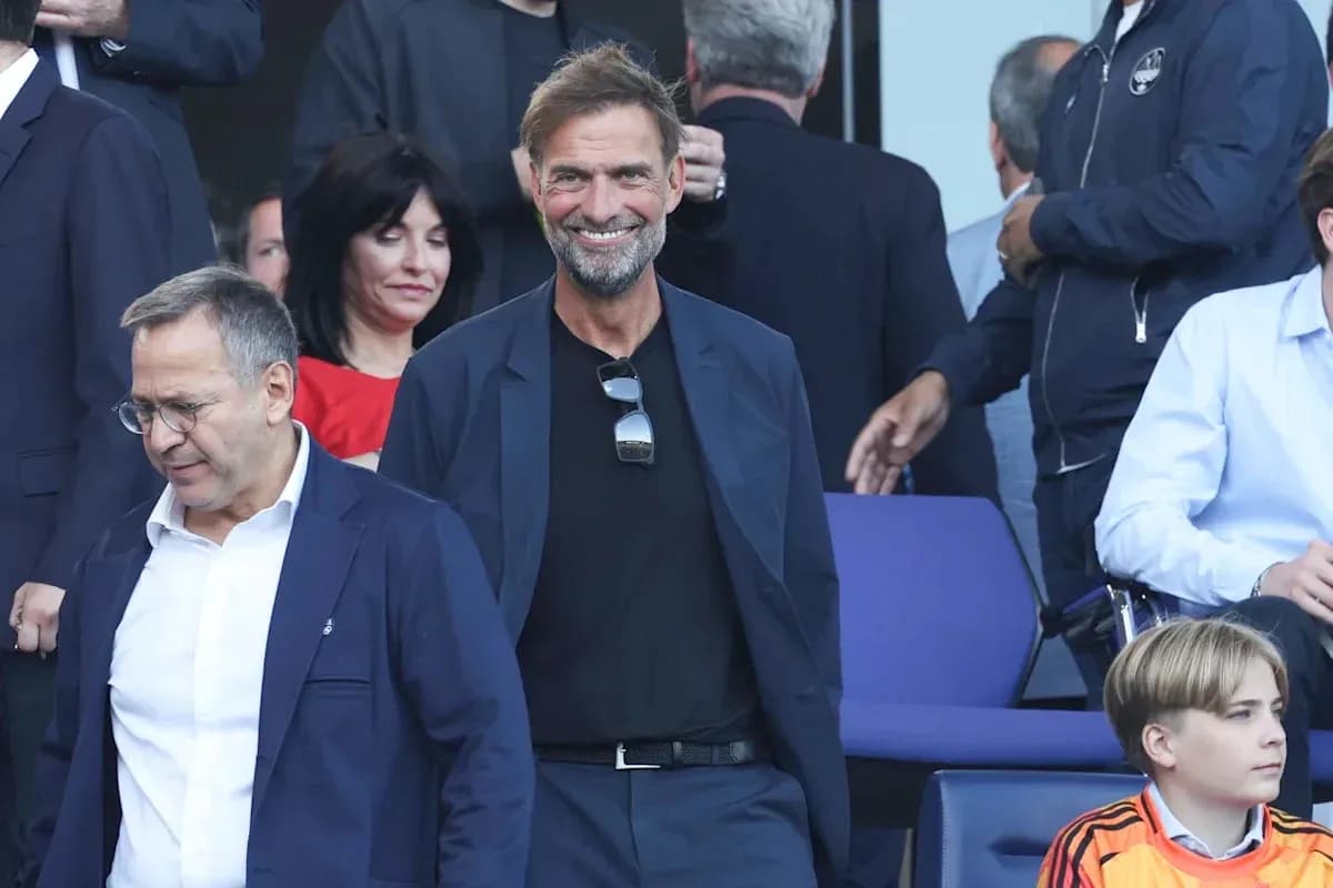 Two men smiling in stands before an event Two men smiling in stands before an event