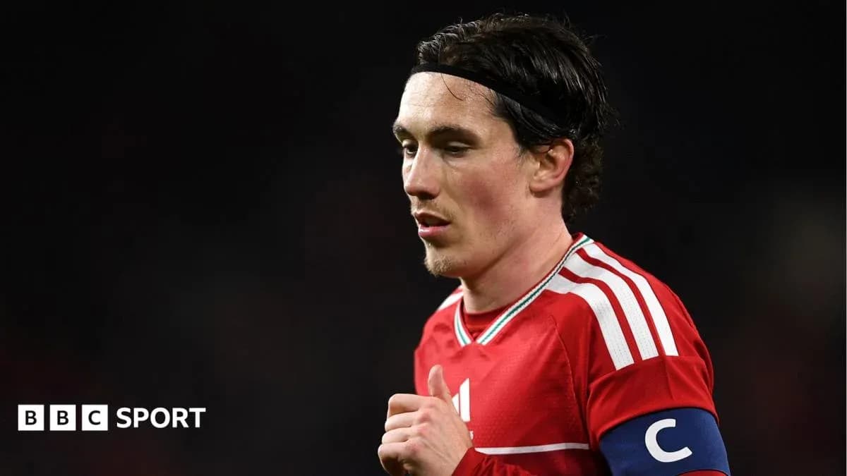 Player wearing red jersey and captain's armband Player wearing red jersey and captain's armband