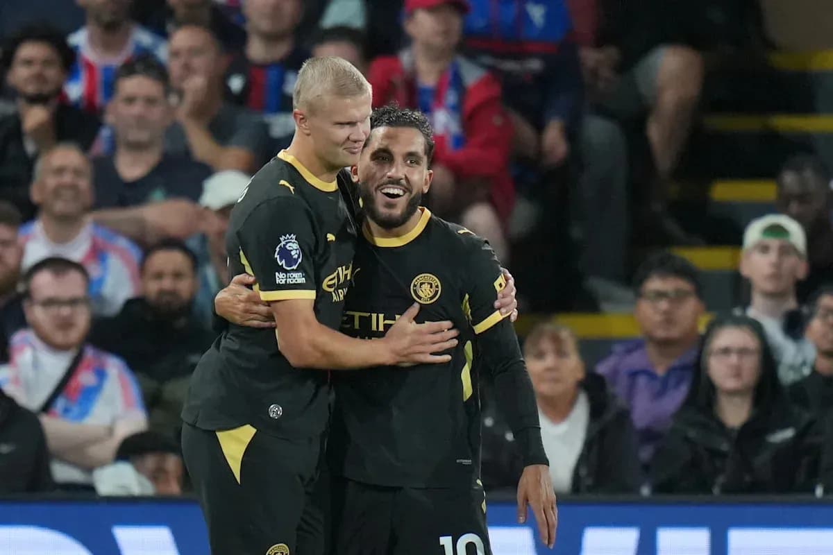 Two players celebrating together on the pitch Two players celebrating together on the pitch
