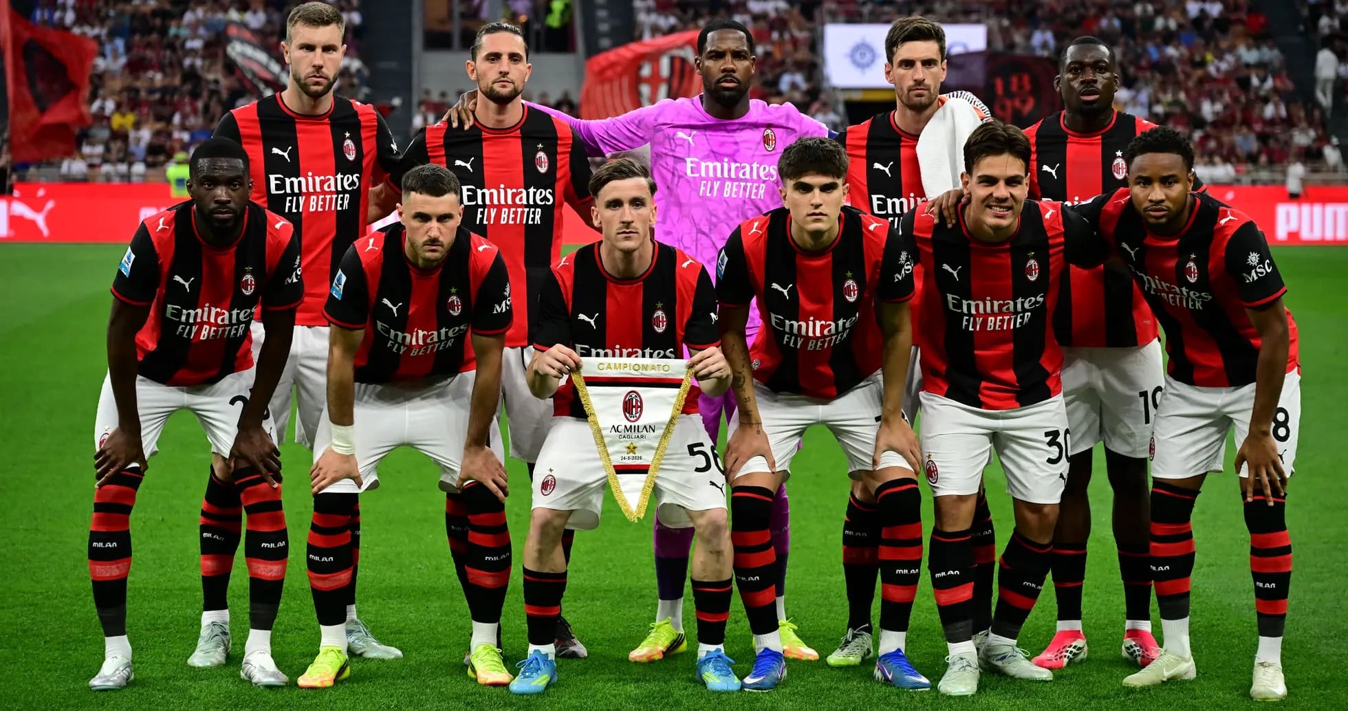 AC Milan team posing with championship banner AC Milan team posing with championship banner