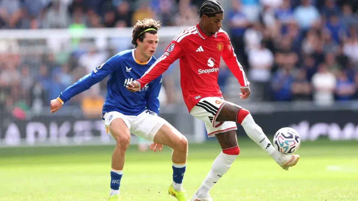 Player dribbling ball while being challenged by opponent Player dribbling ball while being challenged by opponent