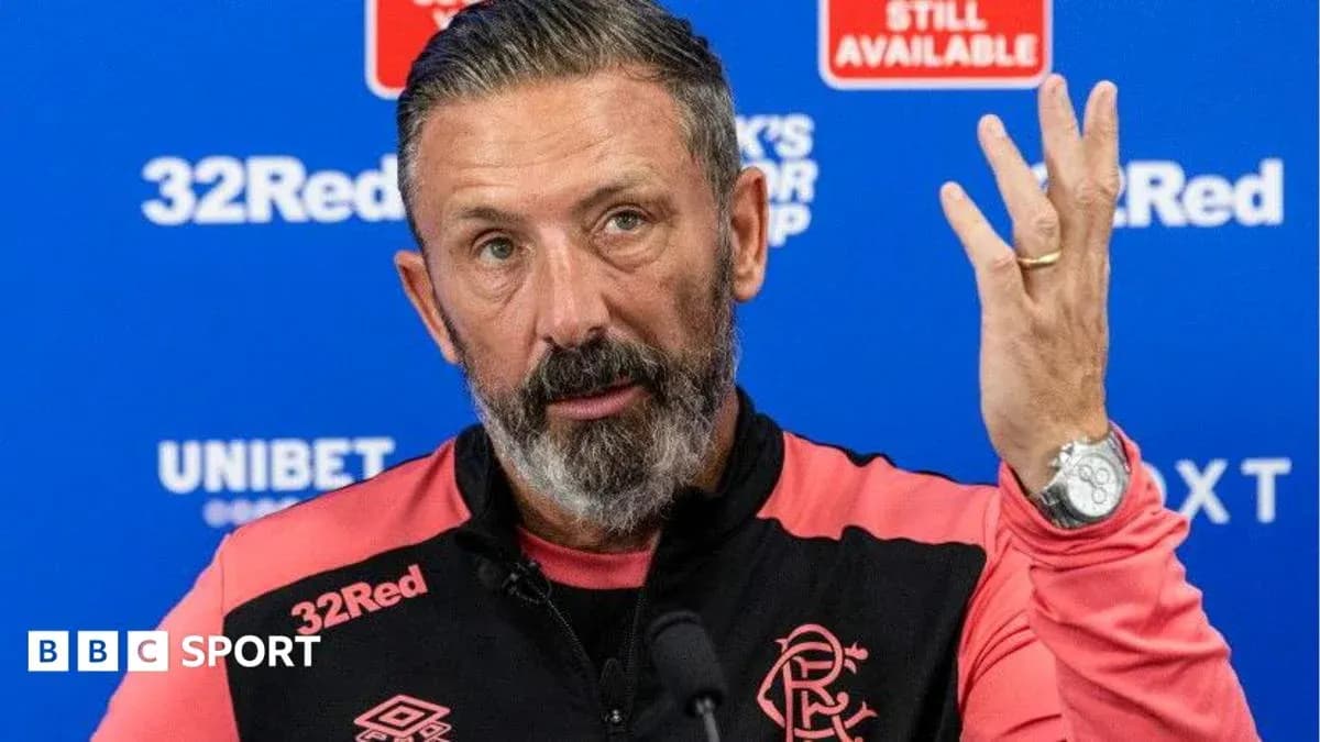 Manager speaking at press conference with raised hand Manager speaking at press conference with raised hand
