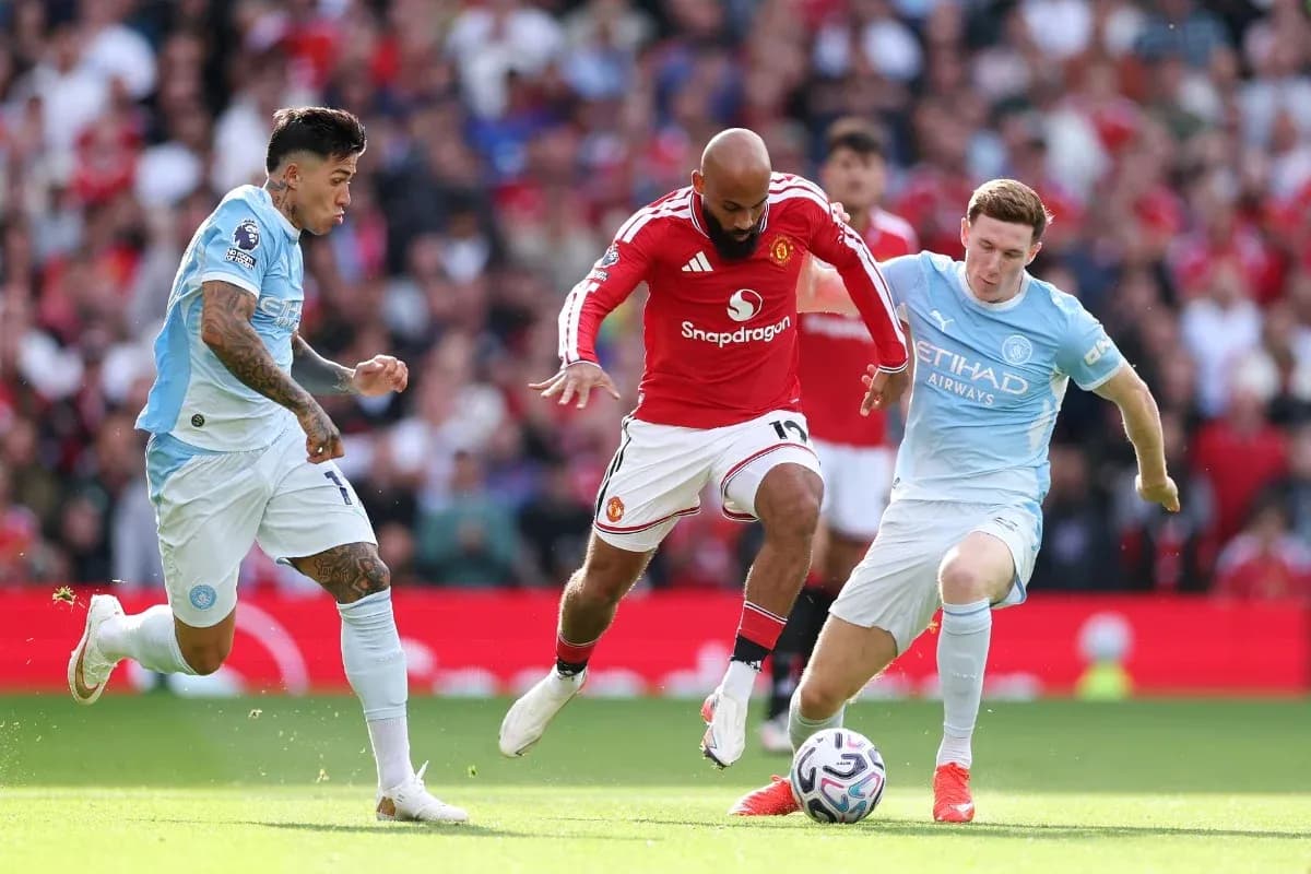Manchester United player challenged by Manchester City defenders Manchester United player challenged by Manchester City defenders