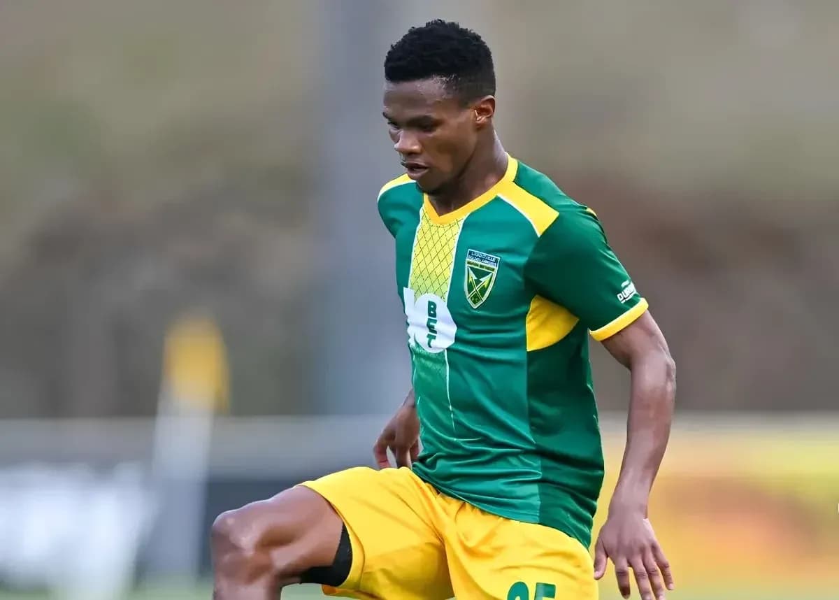 Player in green and yellow kit during match Player in green and yellow kit during match
