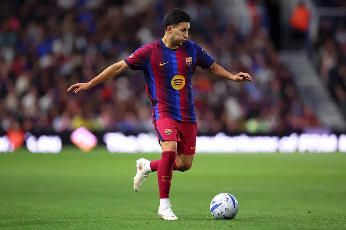 Player in Barcelona kit dribbling soccer ball on field Player in Barcelona kit dribbling soccer ball on field
