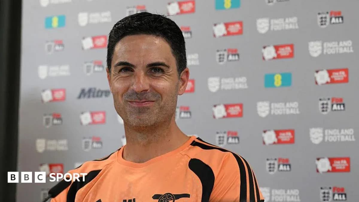Manager smiling during press conference with backdrop Manager smiling during press conference with backdrop