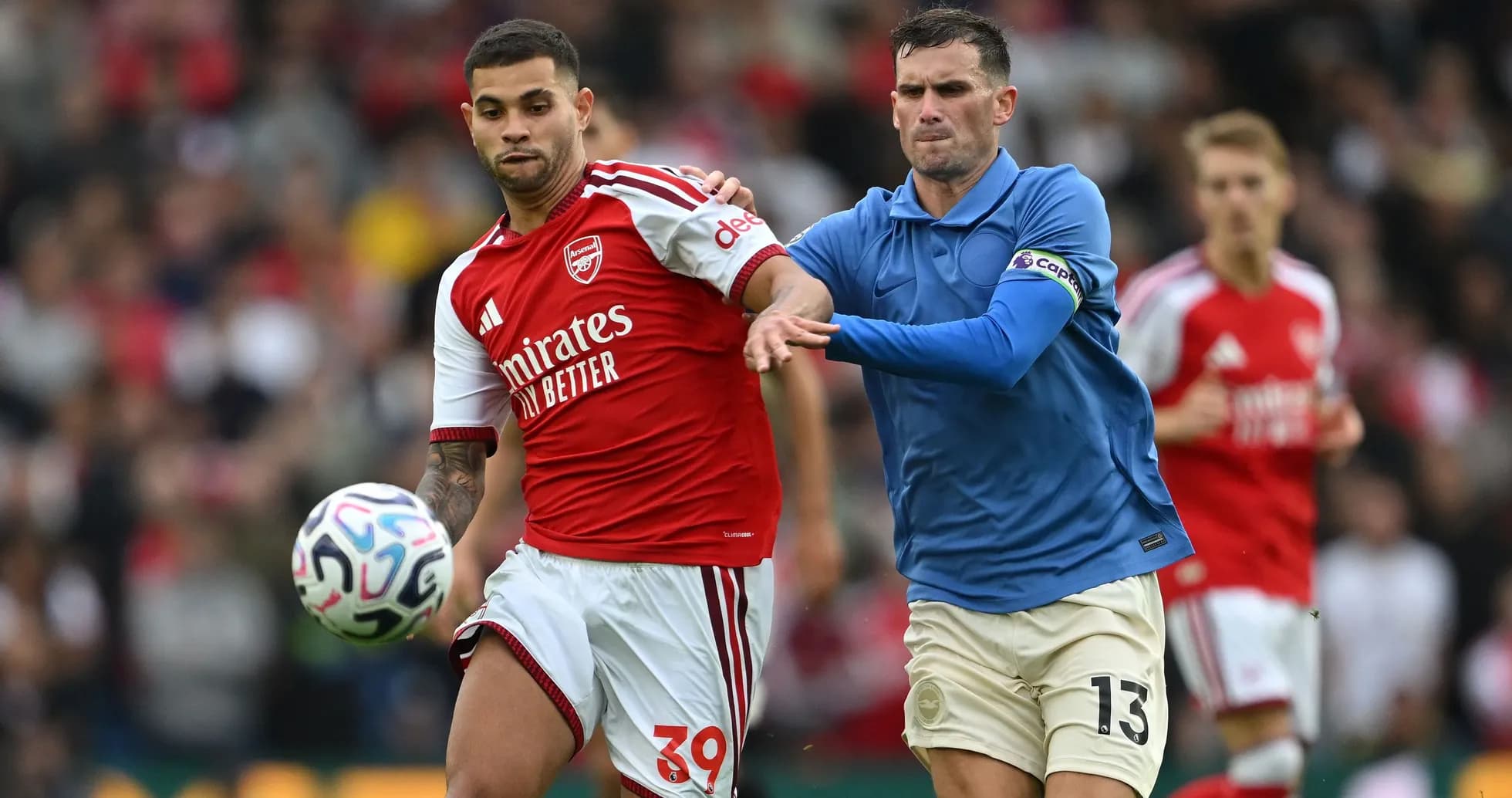 Player in red dribbling past opponent in blue Player in red dribbling past opponent in blue
