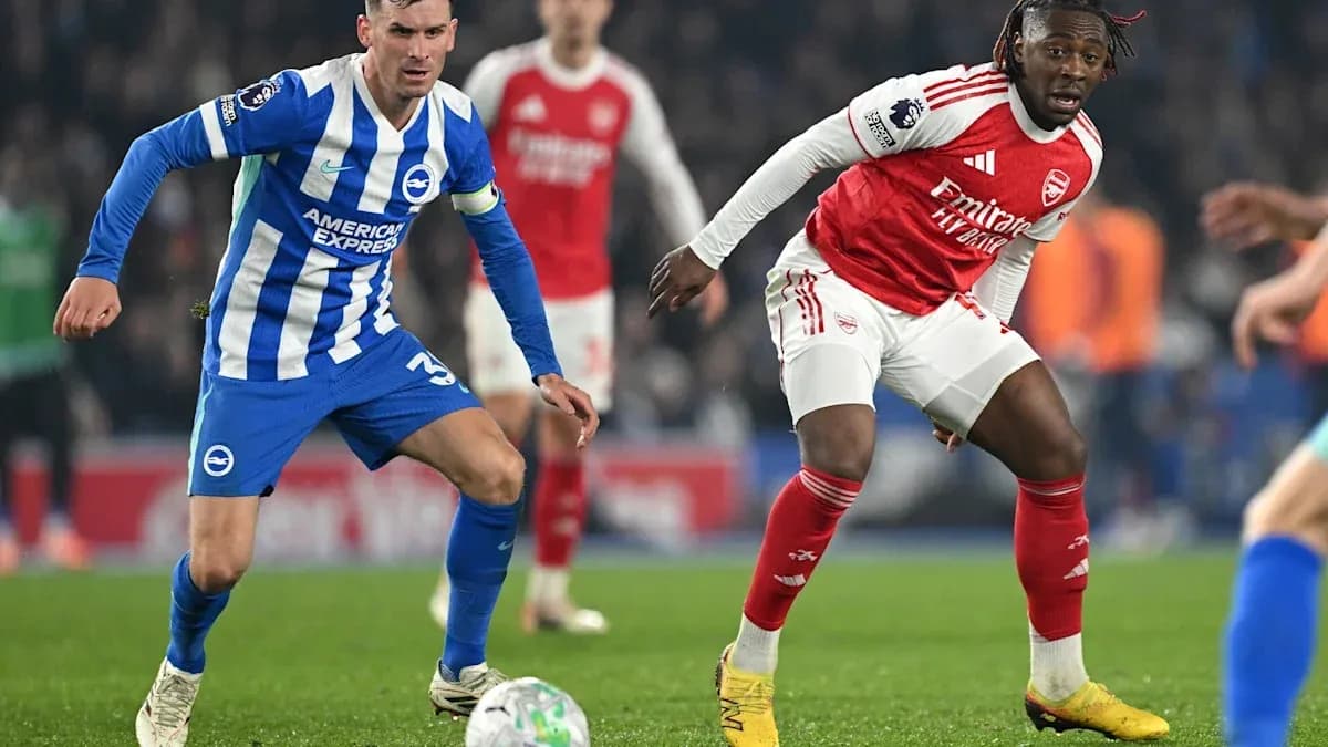 Brighton and Arsenal players competing for the ball Brighton and Arsenal players competing for the ball