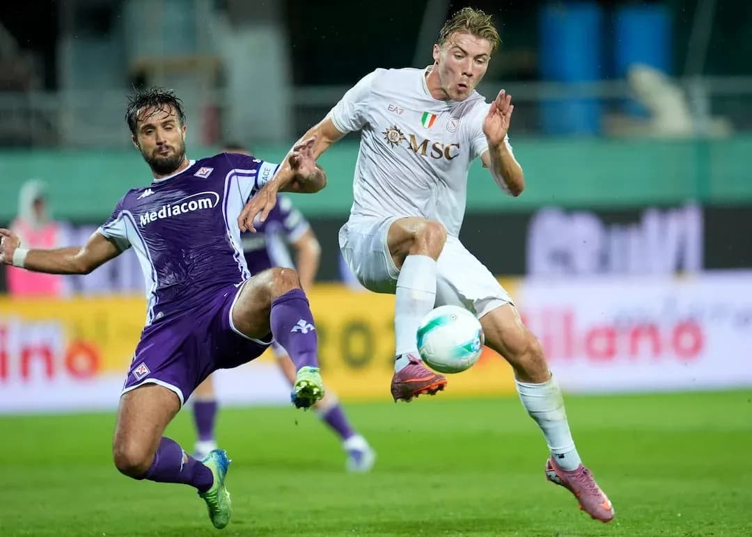 Fiorentina player tackling Napoli opponent during match Fiorentina player tackling Napoli opponent during match
