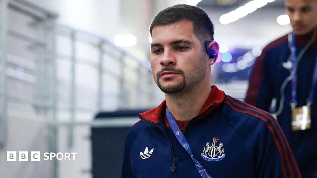 Player entering stadium wearing team tracksuit Player entering stadium wearing team tracksuit