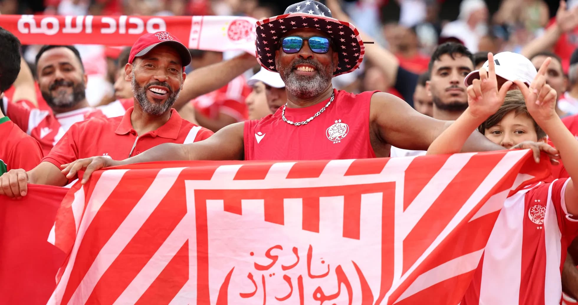 Fans celebrating with a flag at the stadium Fans celebrating with a flag at the stadium