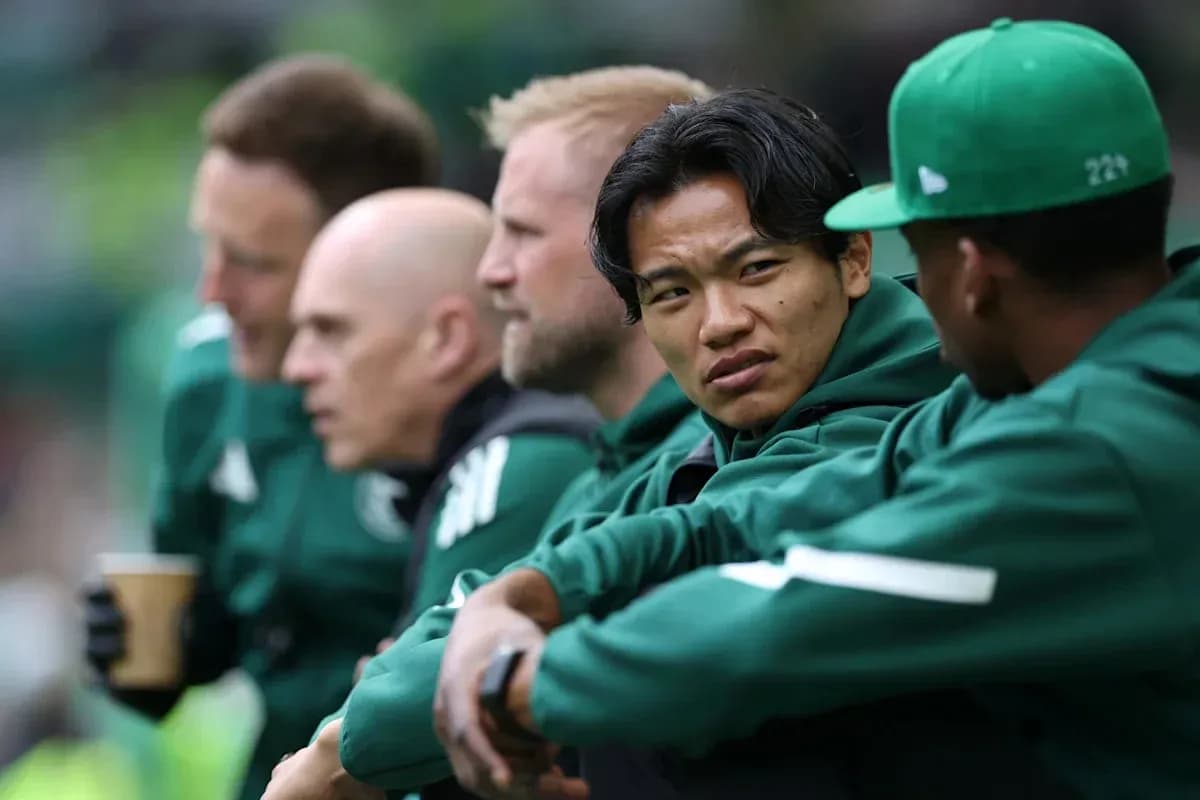 Coaches and players seated on bench during match Coaches and players seated on bench during match