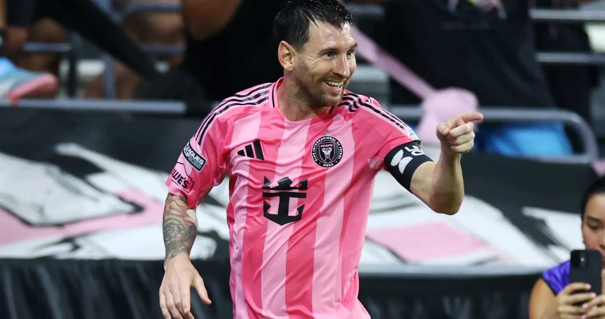 Player celebrating a goal in pink jersey Player celebrating a goal in pink jersey