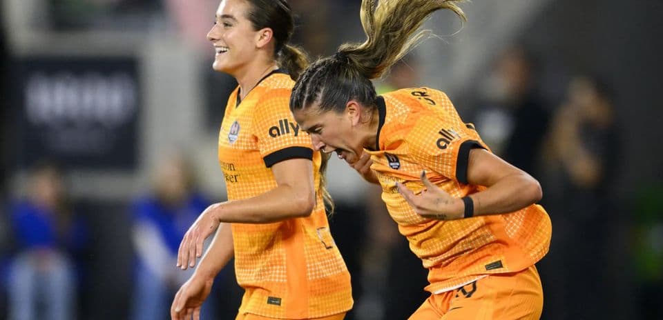 Two Houston Dash players celebrating a goal Two Houston Dash players celebrating a goal