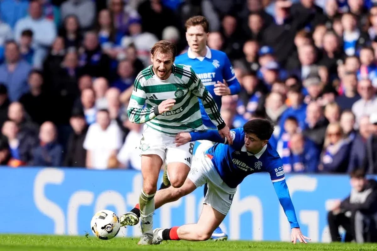 Celtic player evading a tackle during match Celtic player evading a tackle during match