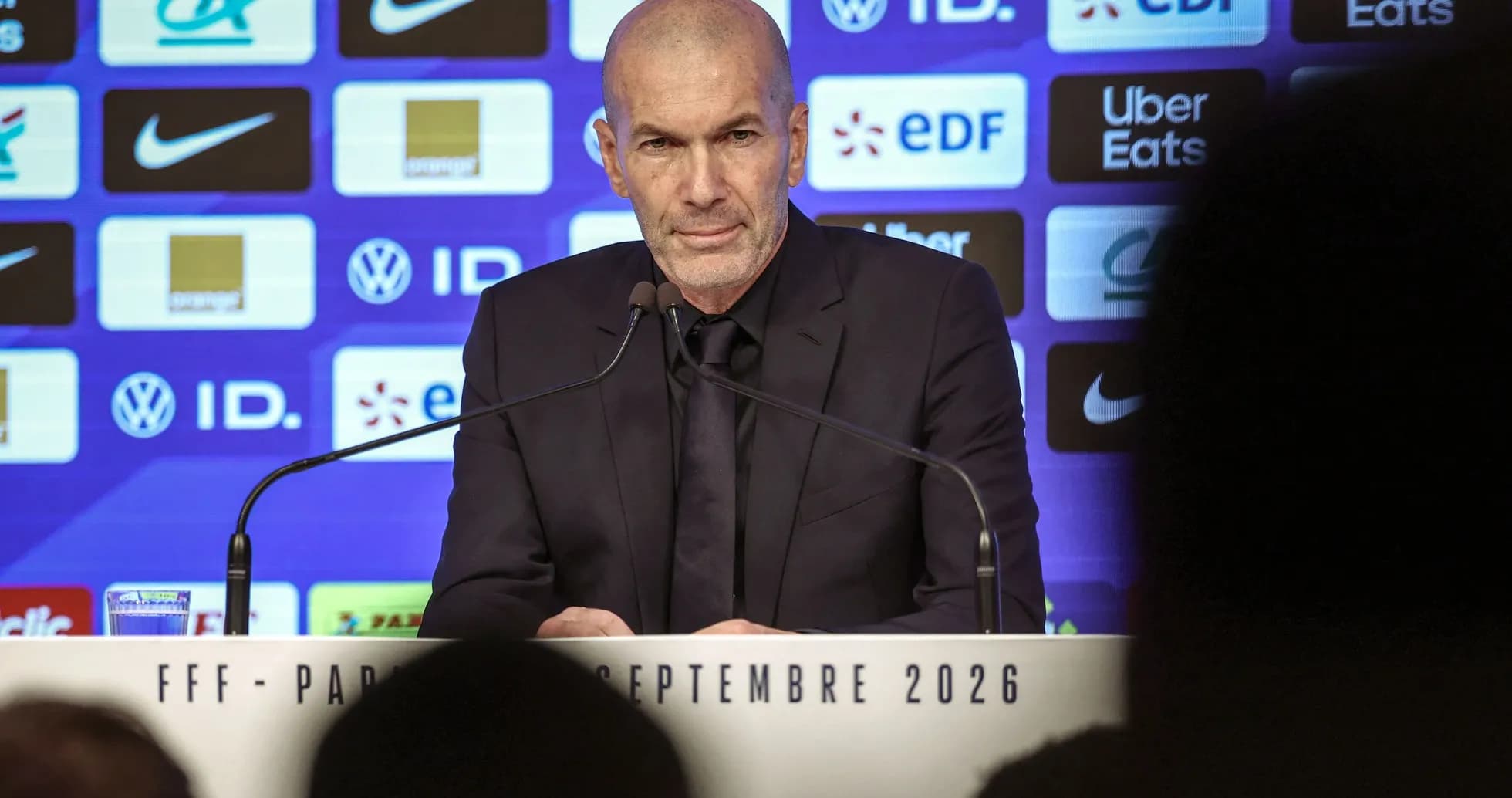 Manager speaking at press conference with logos backdrop Manager speaking at press conference with logos backdrop