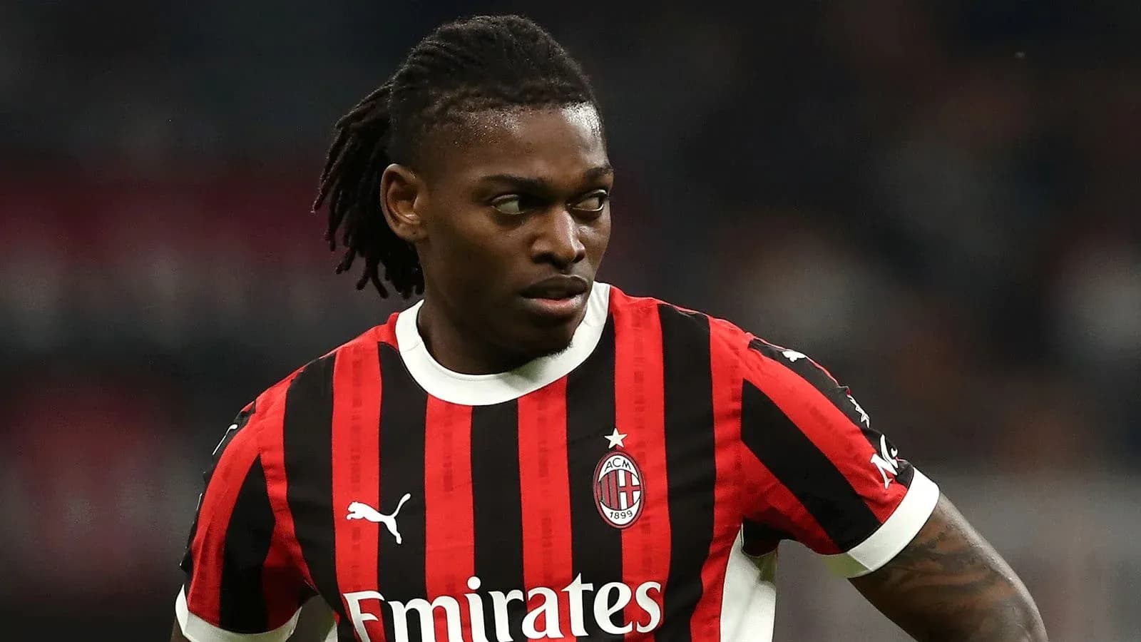 Player in AC Milan jersey during match action Player in AC Milan jersey during match action