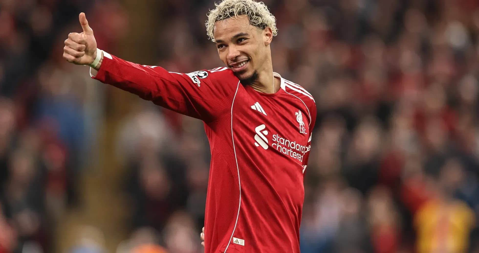 Player celebrating with thumbs up in Liverpool kit Player celebrating with thumbs up in Liverpool kit