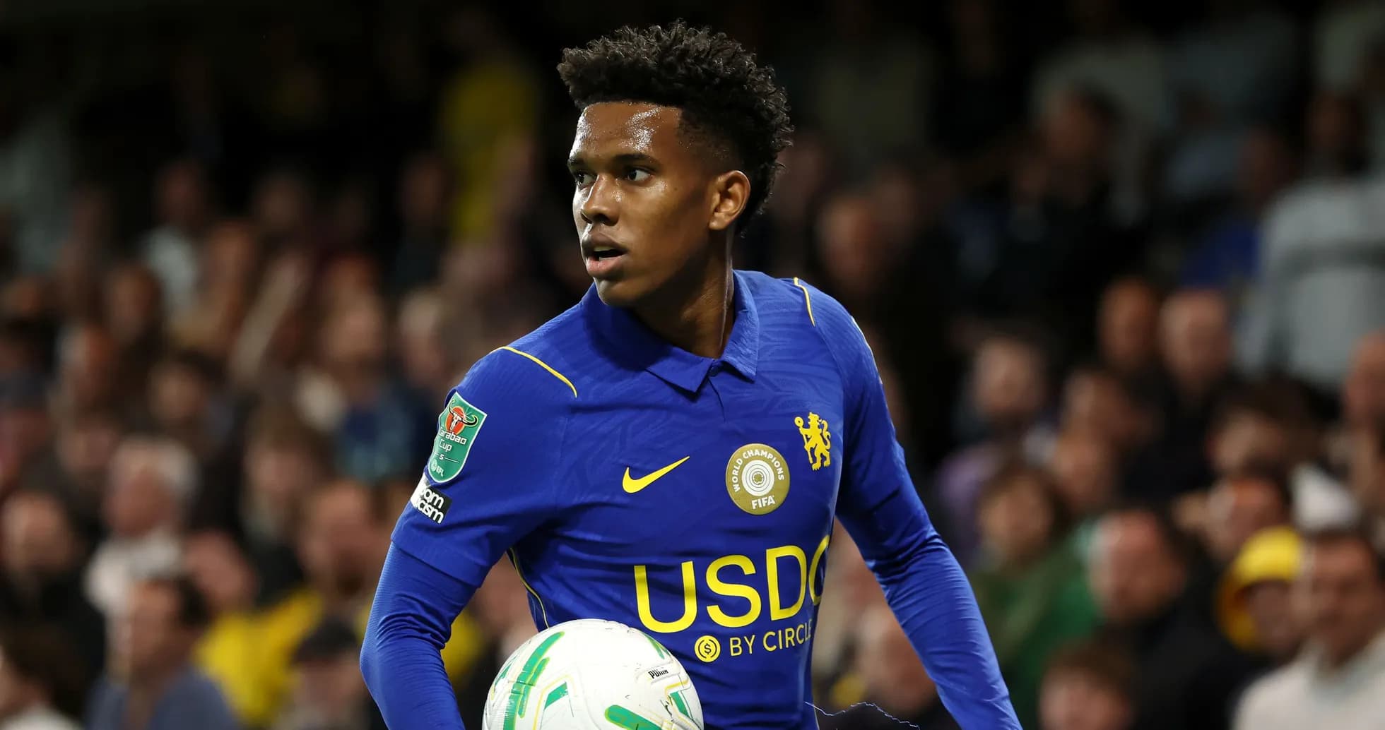 Player in blue jersey holding a football during match Player in blue jersey holding a football during match