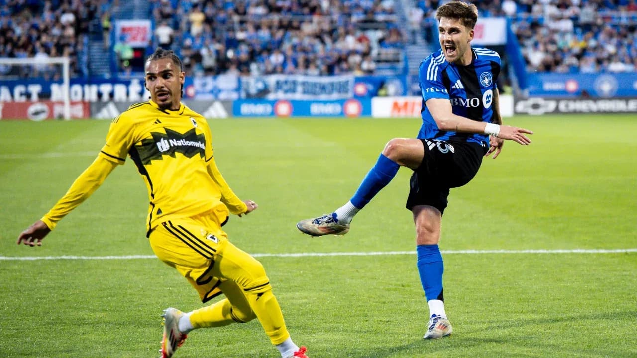 Columbus Crew player defending against CF Montreal Columbus Crew player defending against CF Montreal