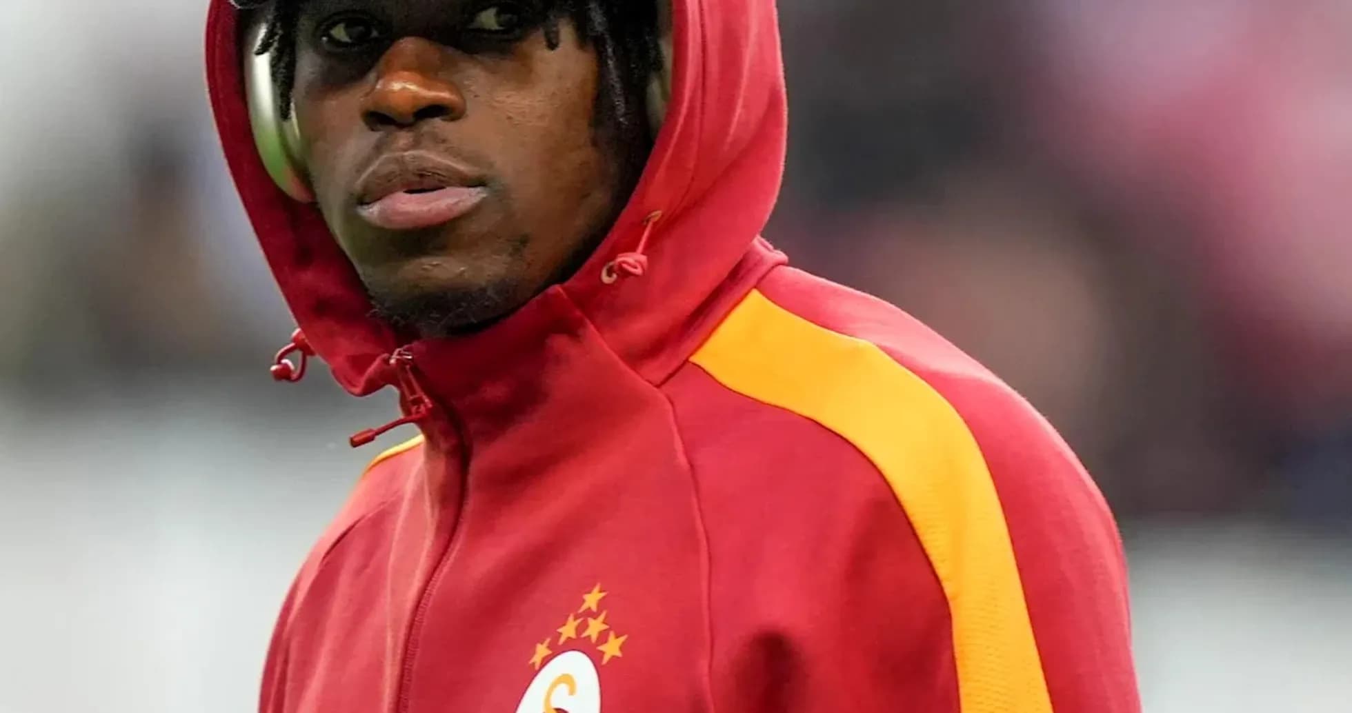 Player in red and yellow jacket during warm-up Player in red and yellow jacket during warm-up