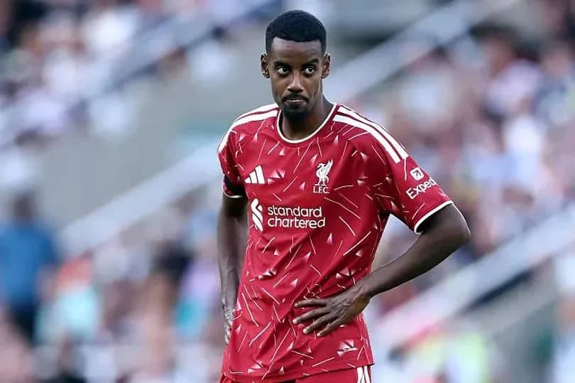 Player wearing Liverpool jersey on the field Player wearing Liverpool jersey on the field