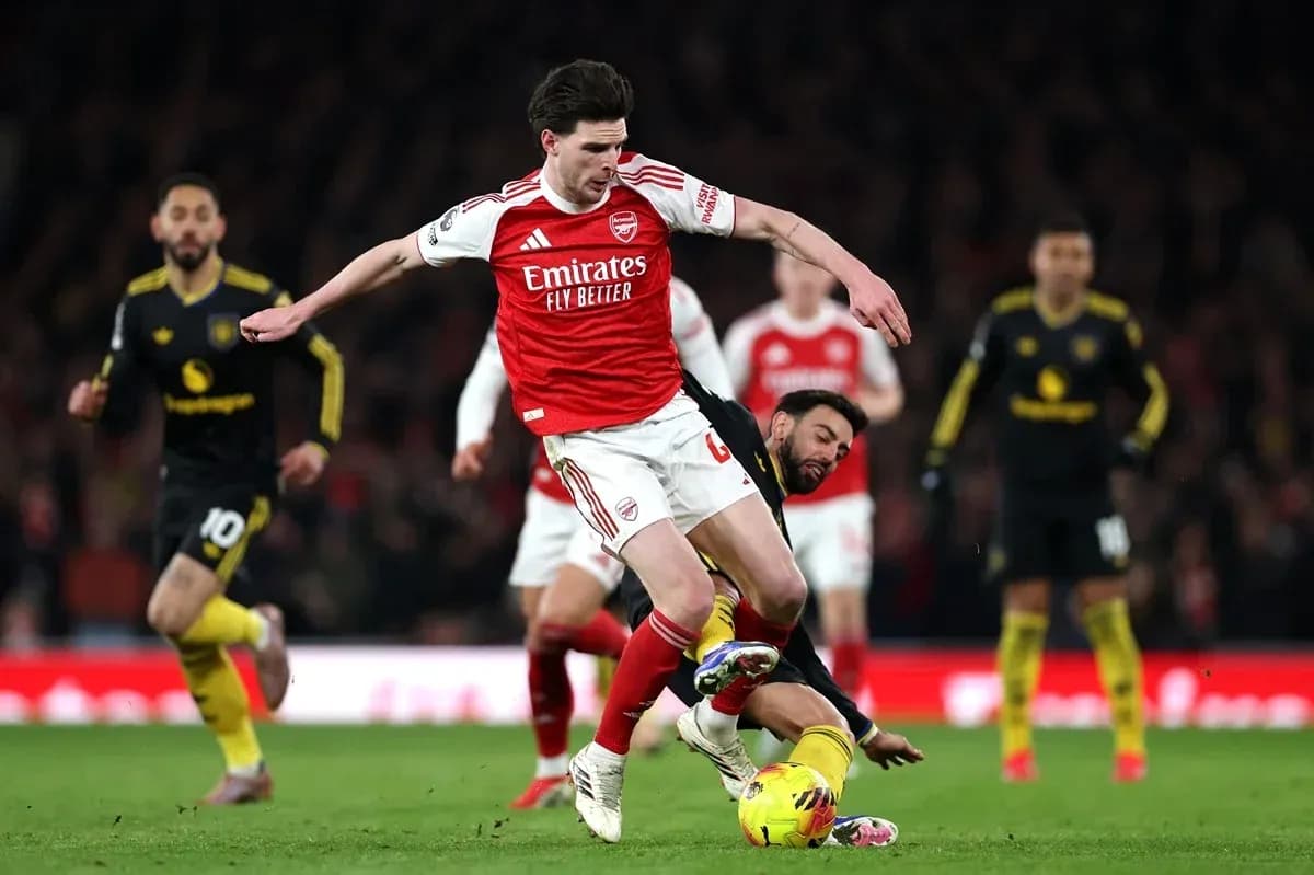 Arsenal player evading tackle during match action Arsenal player evading tackle during match action