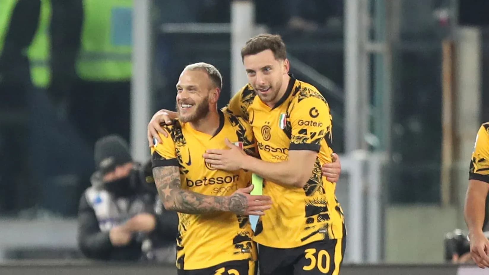Two players celebrating a goal on the field Two players celebrating a goal on the field