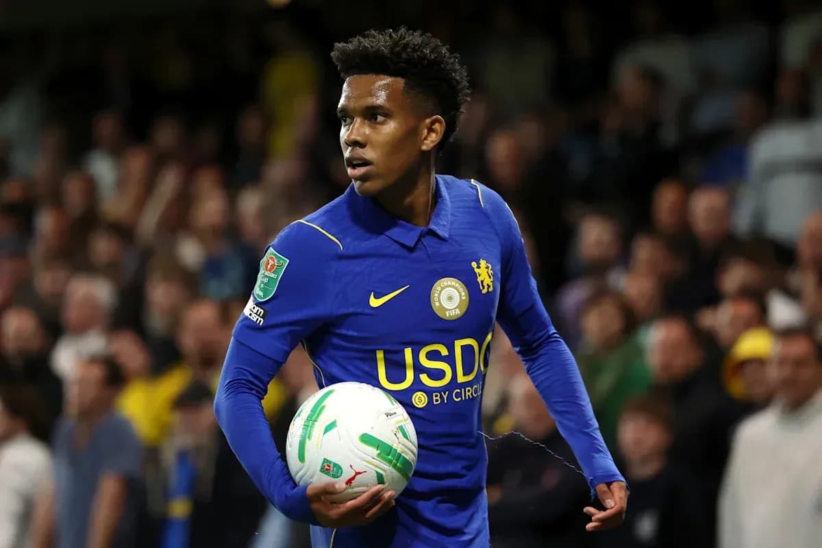 Player in blue jersey holding soccer ball on field Player in blue jersey holding soccer ball on field