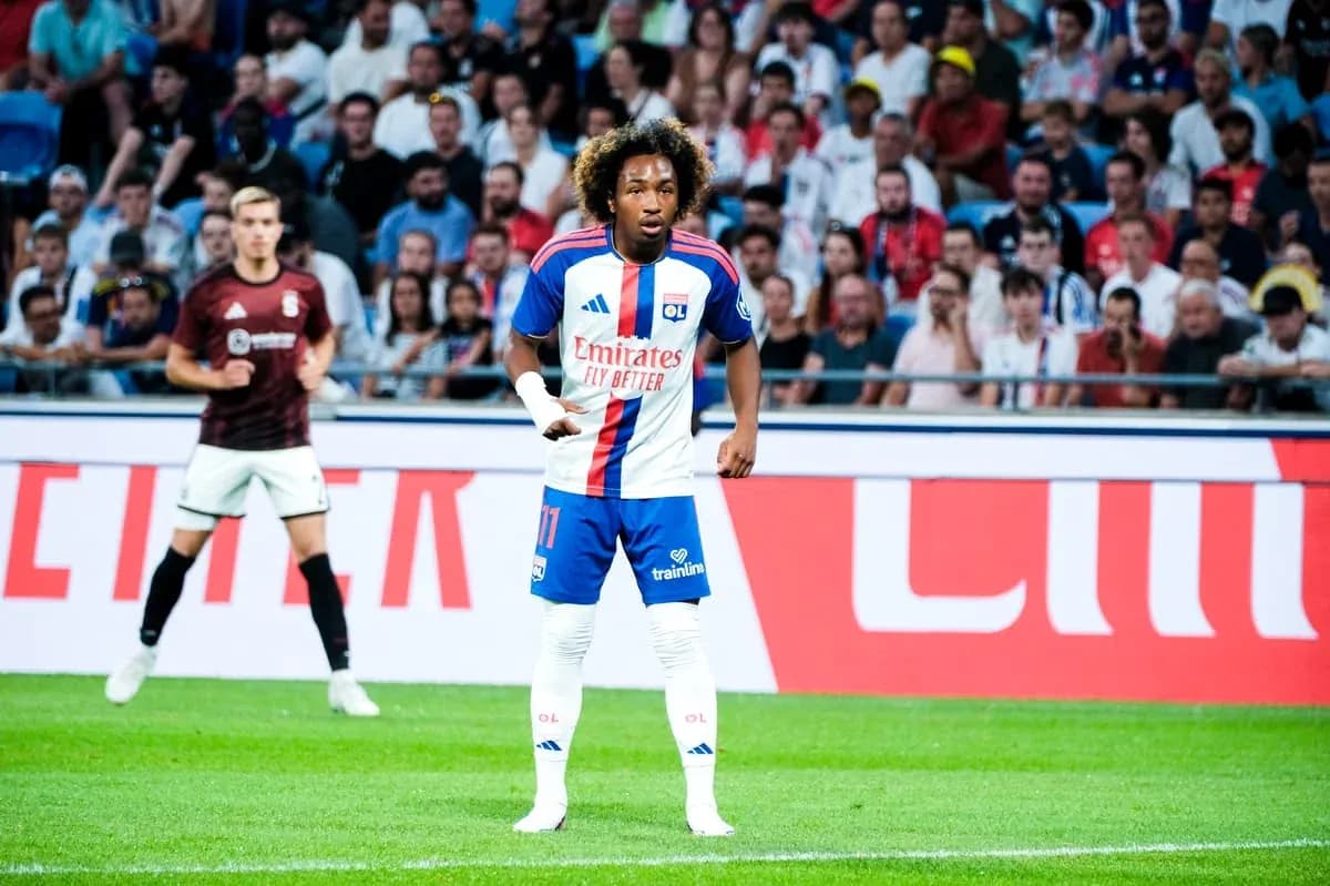 Player wearing Lyon kit during match with crowd behind Player wearing Lyon kit during match with crowd behind