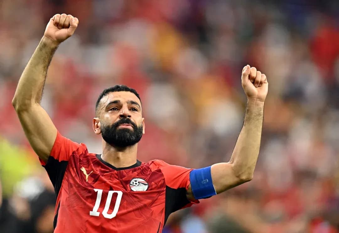 Egyptian player celebrating with raised fists on field Egyptian player celebrating with raised fists on field