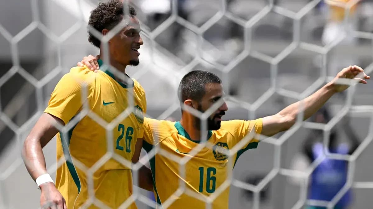 Two Australian players celebrating a goal on field Two Australian players celebrating a goal on field