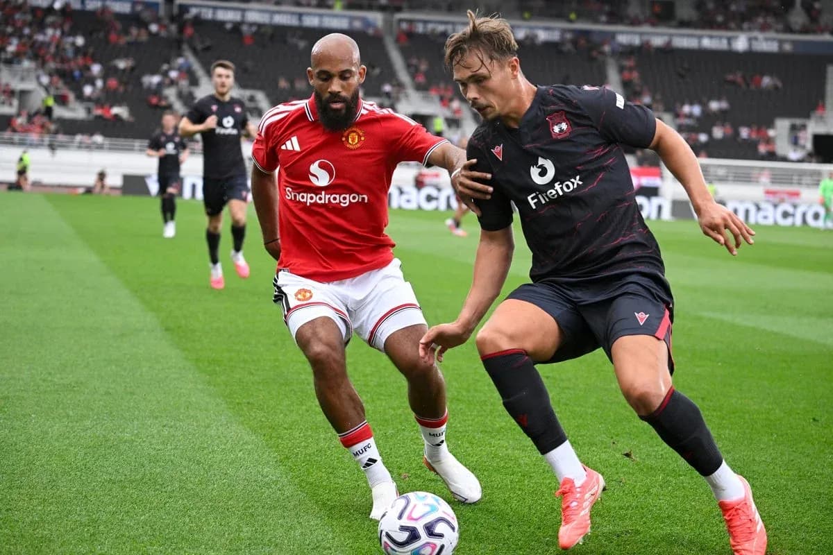 Two players contesting for the ball on field Two players contesting for the ball on field
