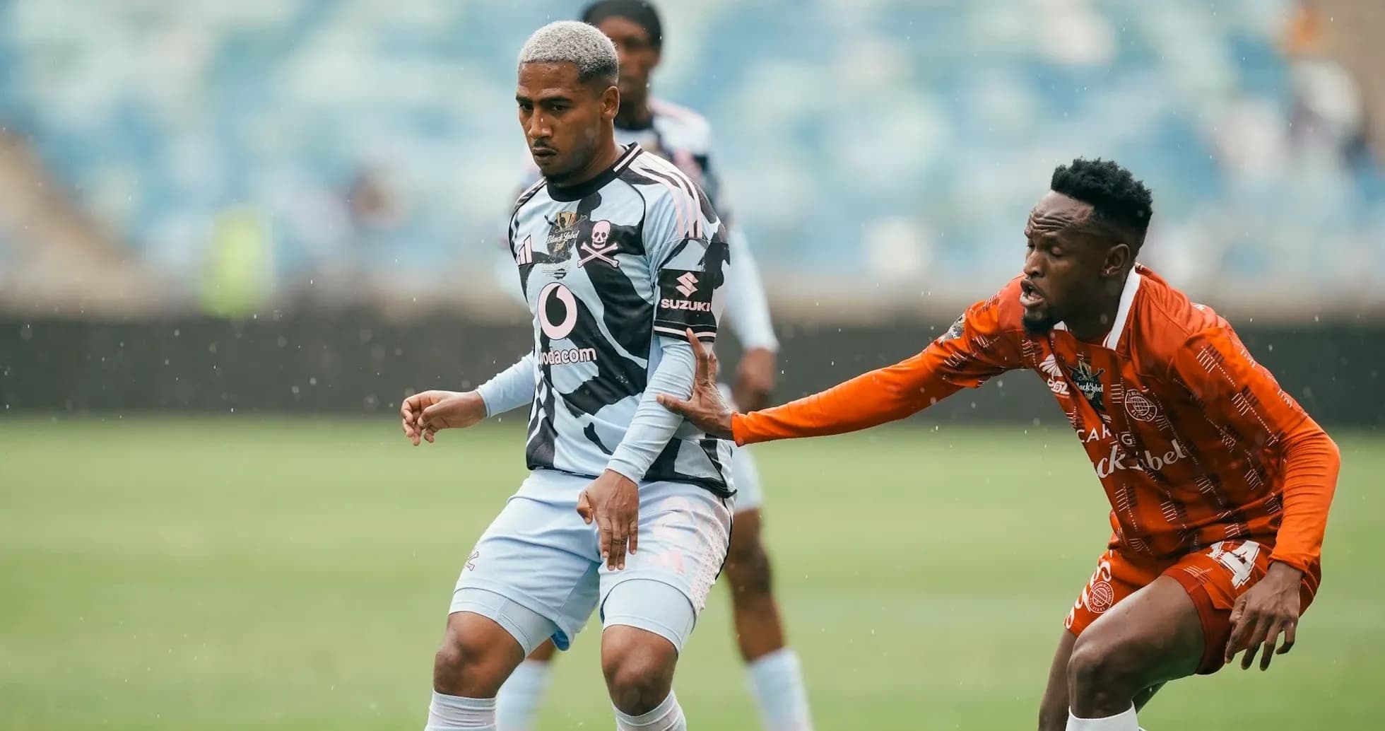 Player in blue jersey being challenged by opponent Player in blue jersey being challenged by opponent