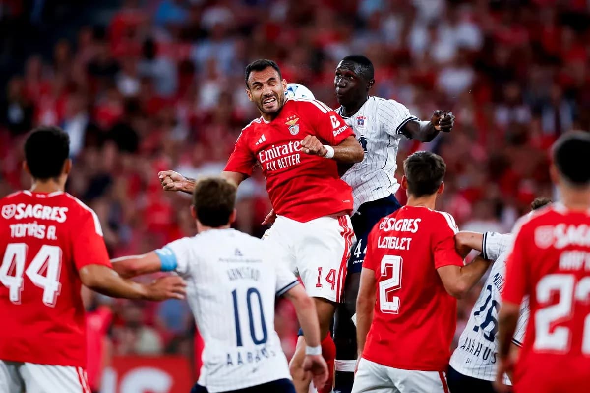 Benfica player challenged by Aarhus defender Benfica player challenged by Aarhus defender