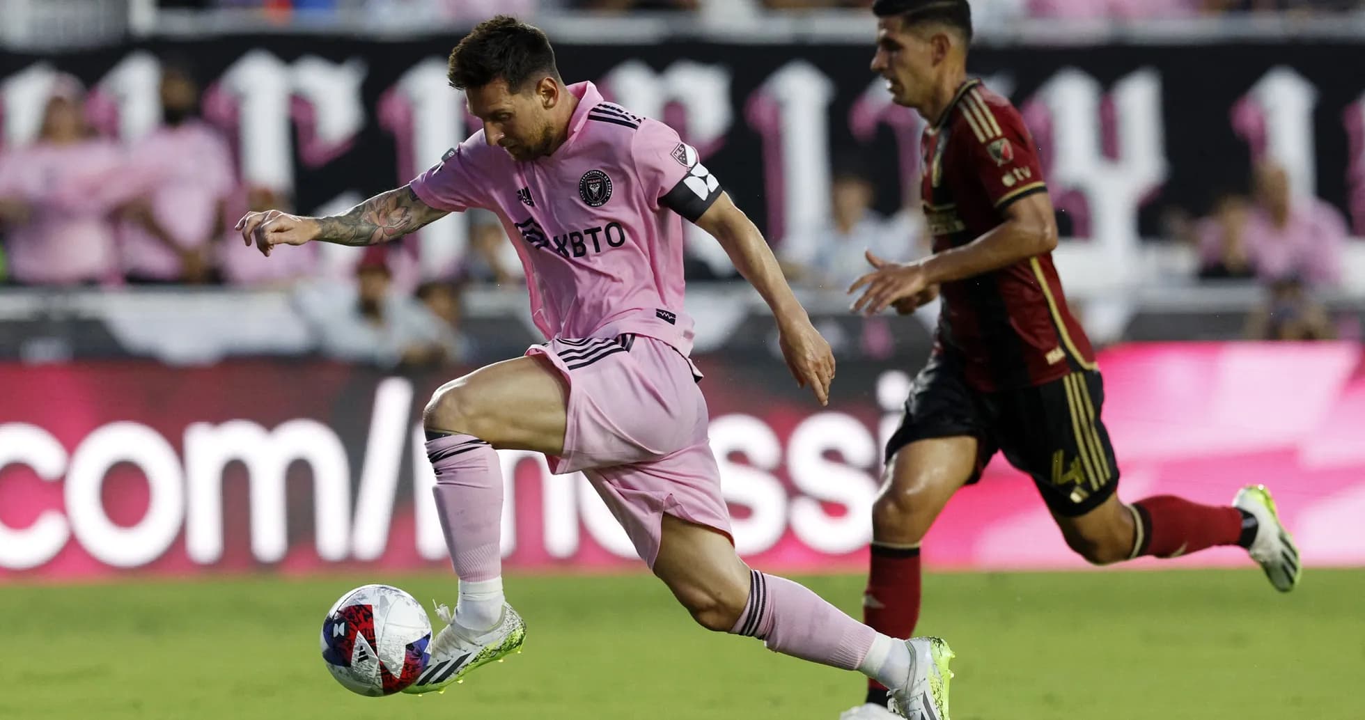 Lionel Messi dribbling past Atlanta United player Lionel Messi dribbling past Atlanta United player
