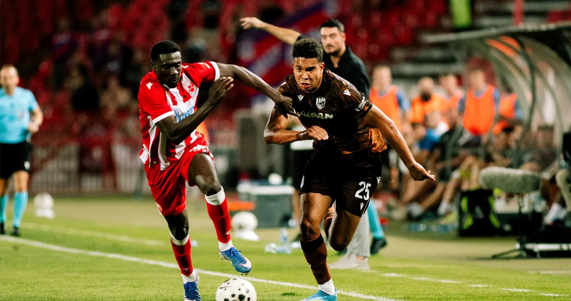 Two players competing for the ball in match Two players competing for the ball in match