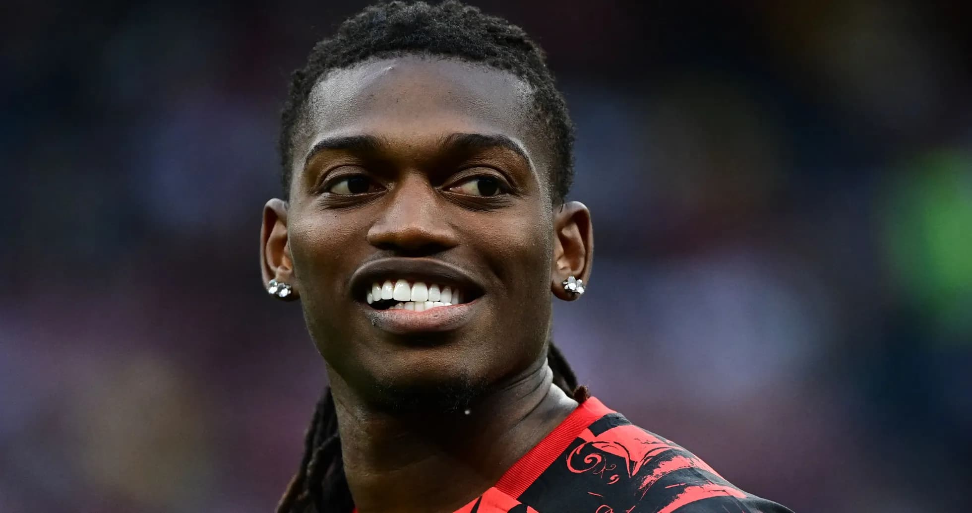 Player smiling while wearing a red jersey Player smiling while wearing a red jersey
