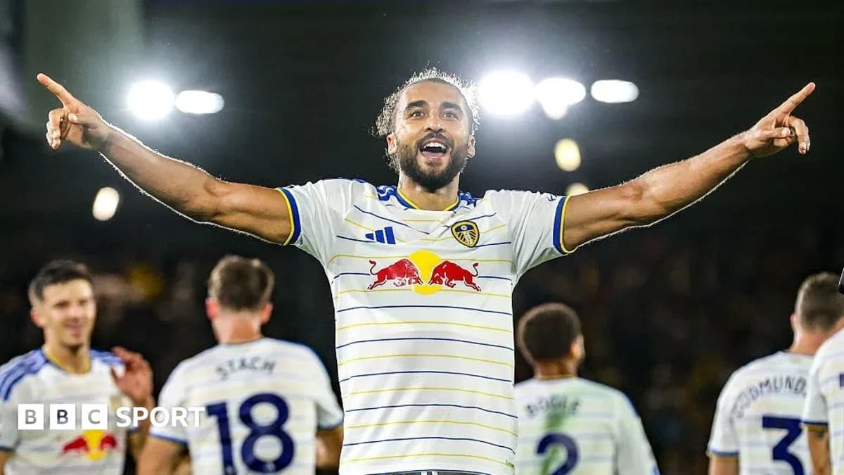 Player celebrating with arms raised during match Player celebrating with arms raised during match
