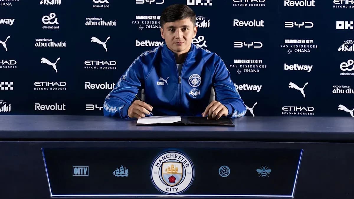 Player signing contract at Manchester City press conference Player signing contract at Manchester City press conference