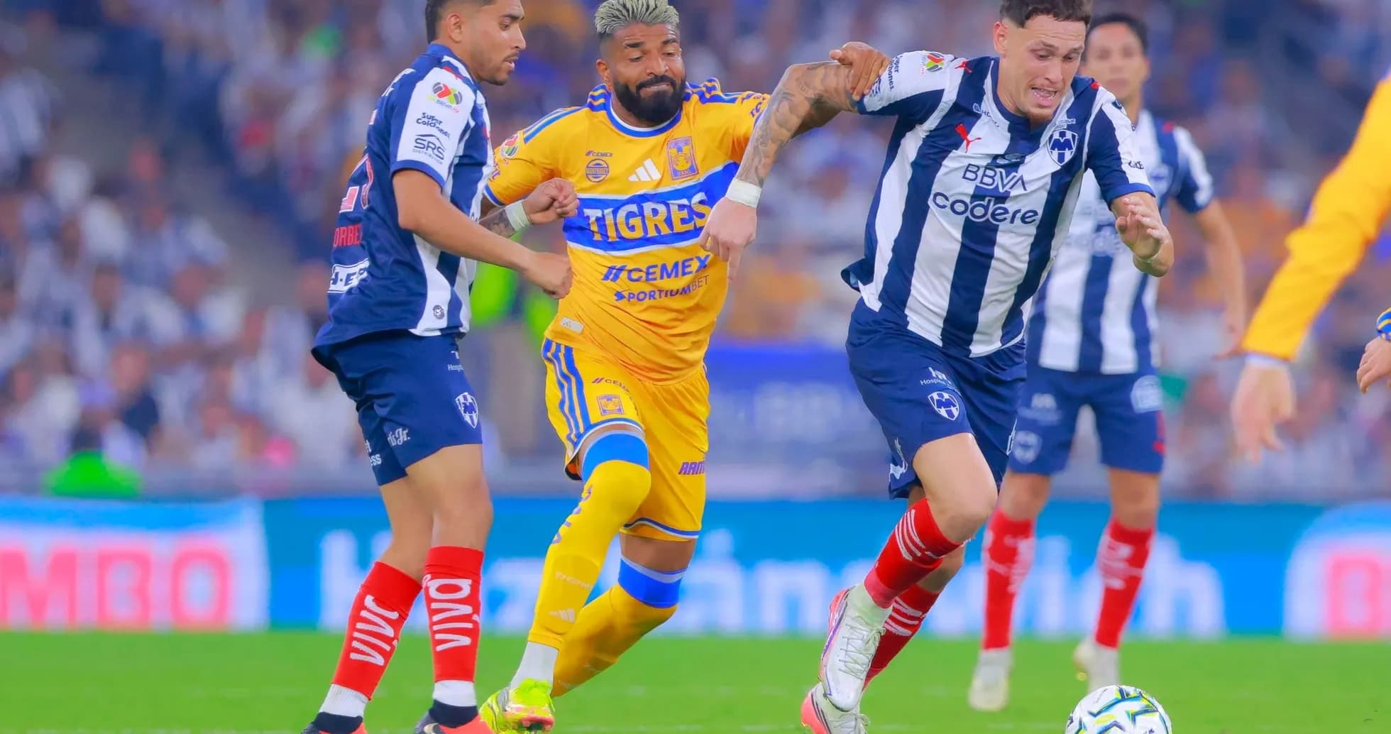 Players competing for the ball in Liga MX match Players competing for the ball in Liga MX match