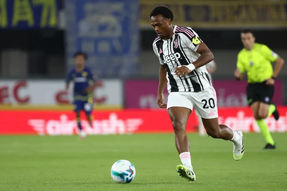 Player in Juventus kit dribbling ball during match Player in Juventus kit dribbling ball during match