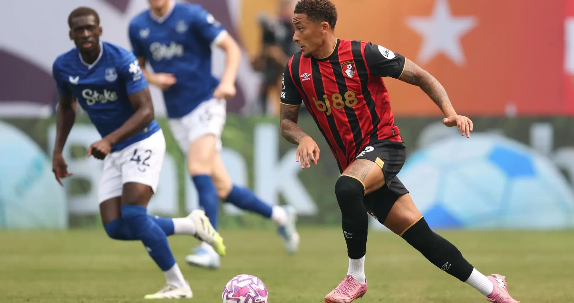 Bournemouth player dribbling past Everton defenders Bournemouth player dribbling past Everton defenders