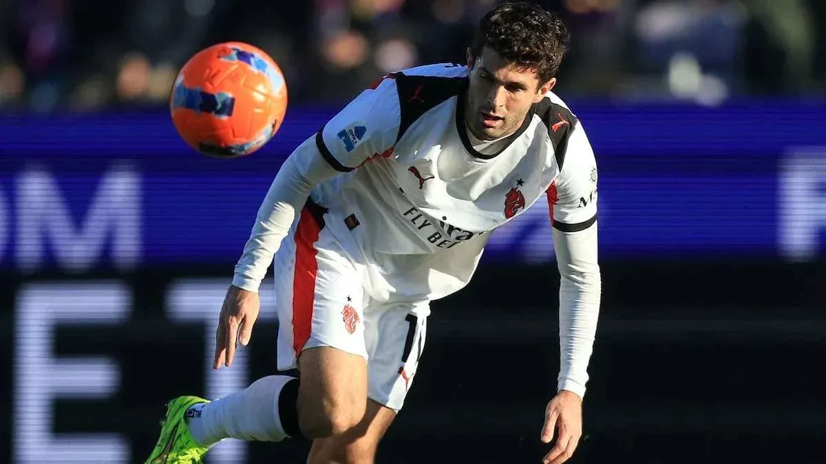 Player in white kit controlling a soccer ball Player in white kit controlling a soccer ball