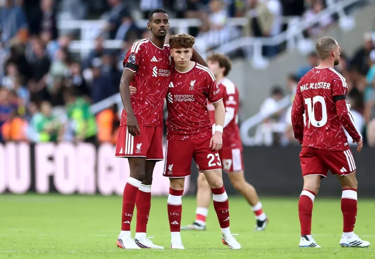 Two Liverpool players in red kits during match Two Liverpool players in red kits during match