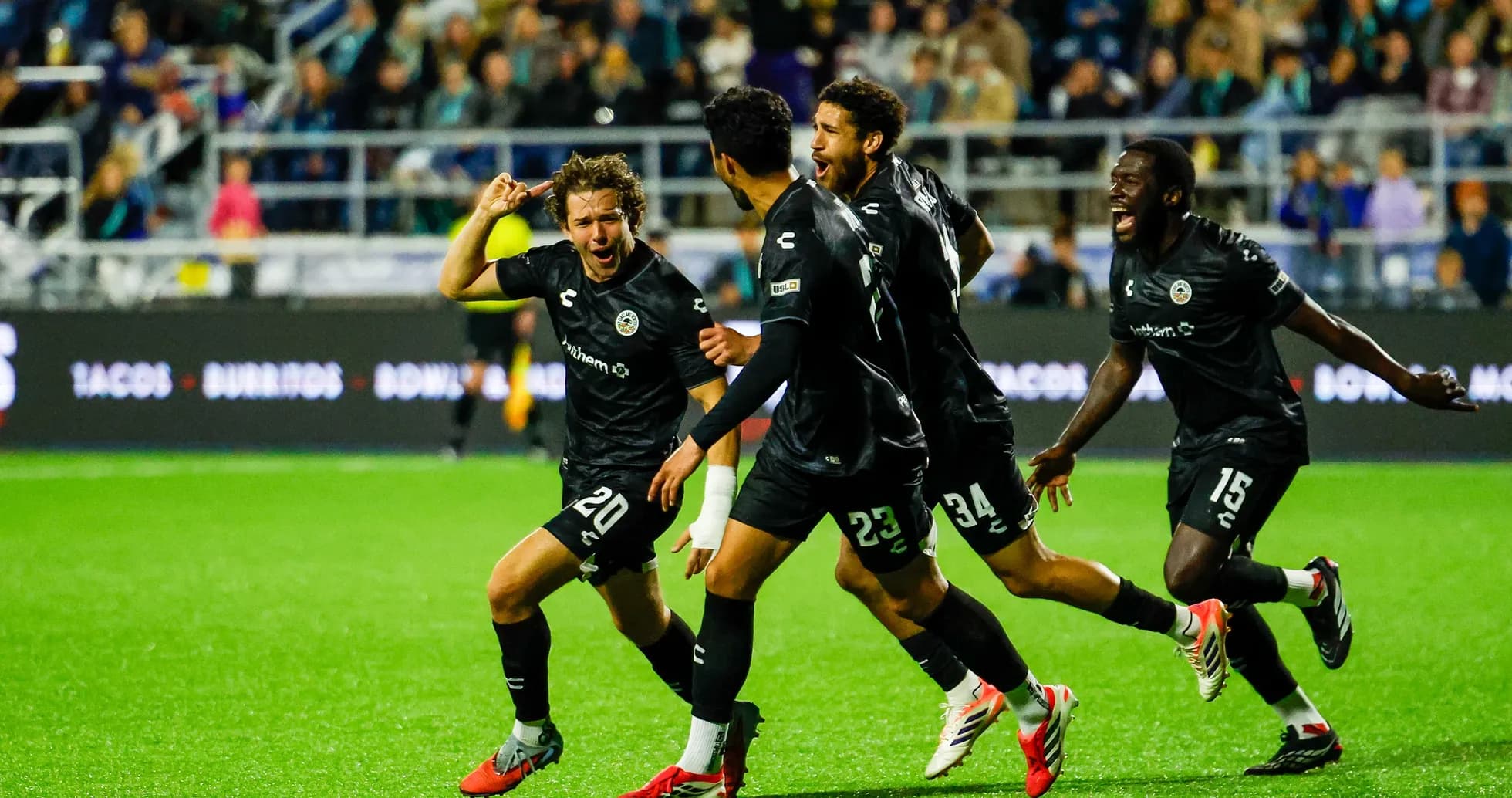 Oakland Roots players celebrating a goal Oakland Roots players celebrating a goal