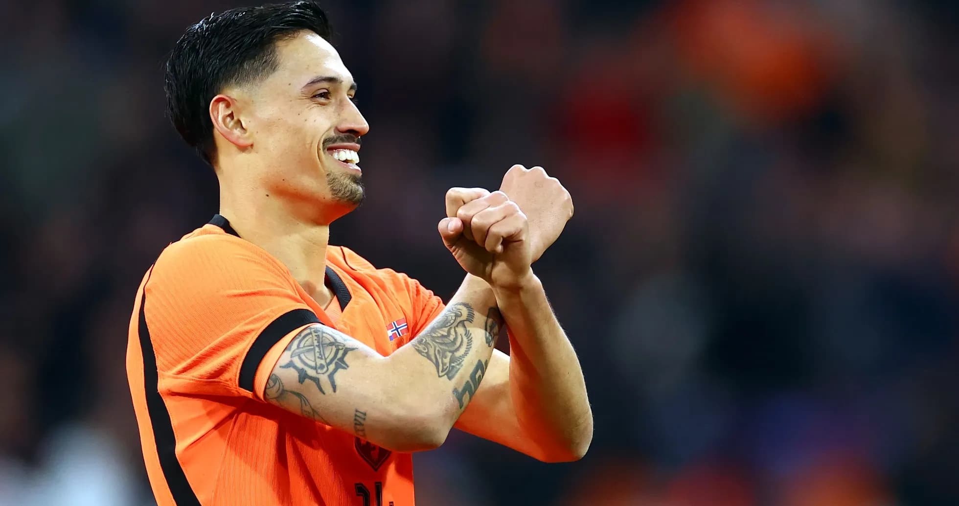 Player celebrating with crossed arms in orange jersey Player celebrating with crossed arms in orange jersey
