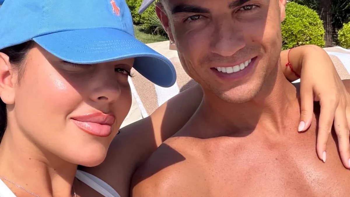 Couple posing for selfie by poolside Couple posing for selfie by poolside