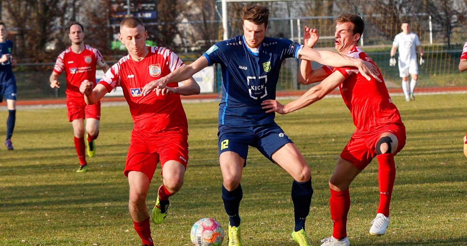 Players competing for the ball in football match Players competing for the ball in football match